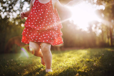 Child dancing with joy and ease while barefoot